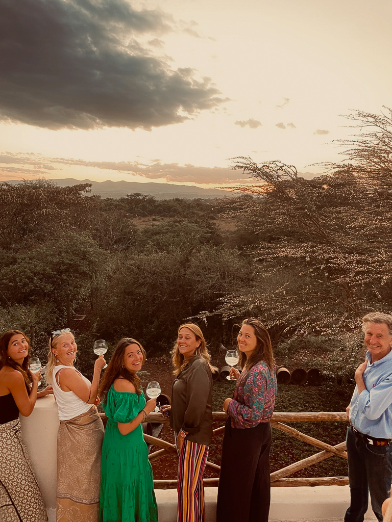 Friends raising glasses at sunset on the rooftop