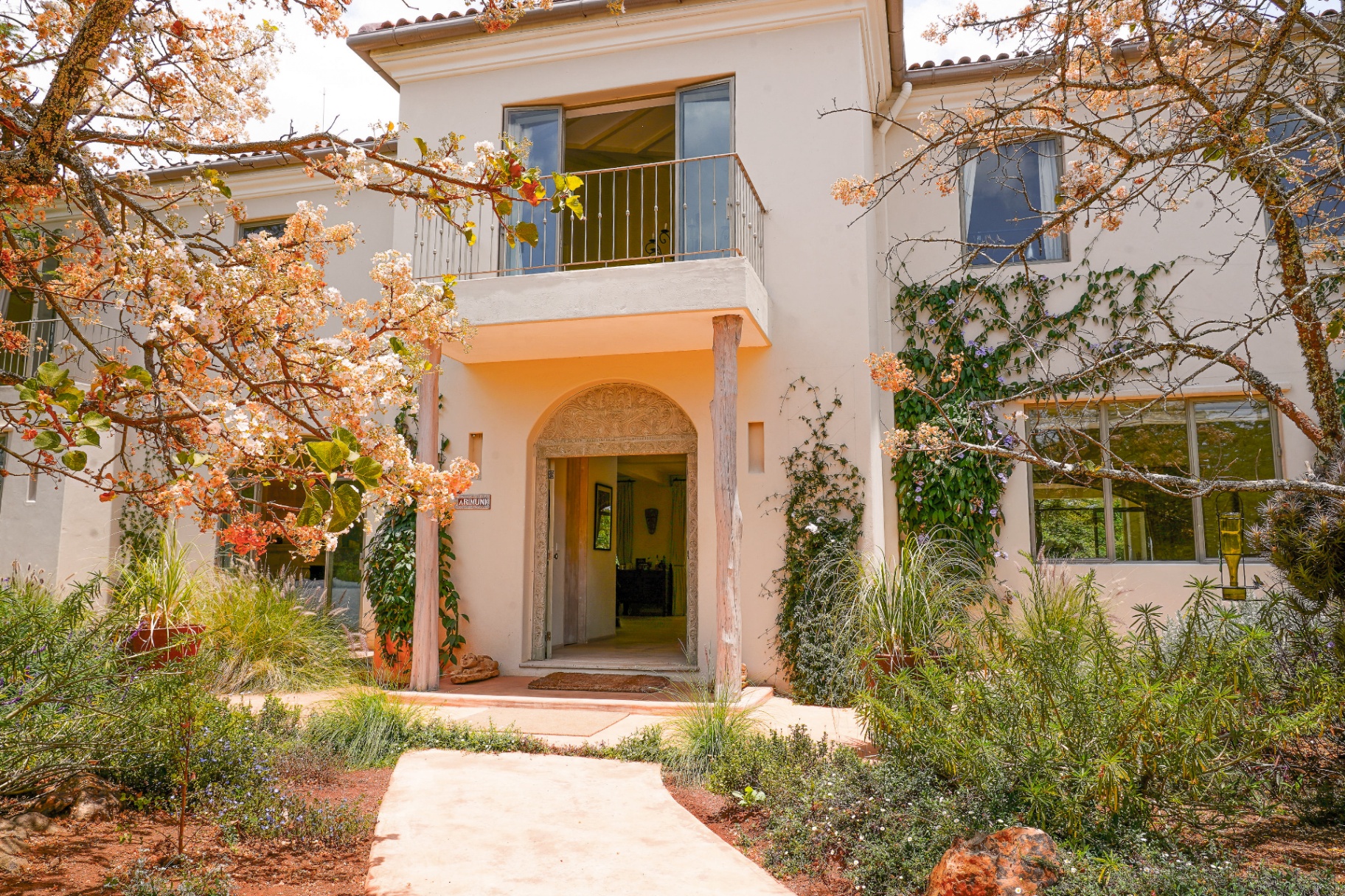 Arimuni House entrance framed by bougainvillea