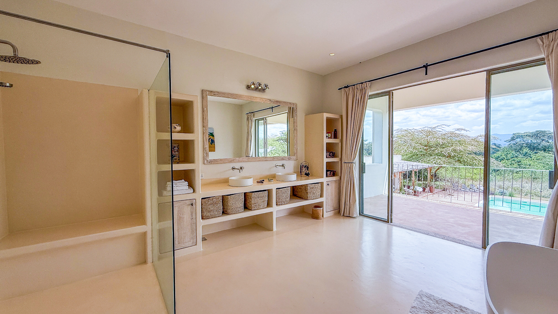 Ensuite bathroom with double vanity opening onto the pool terrace