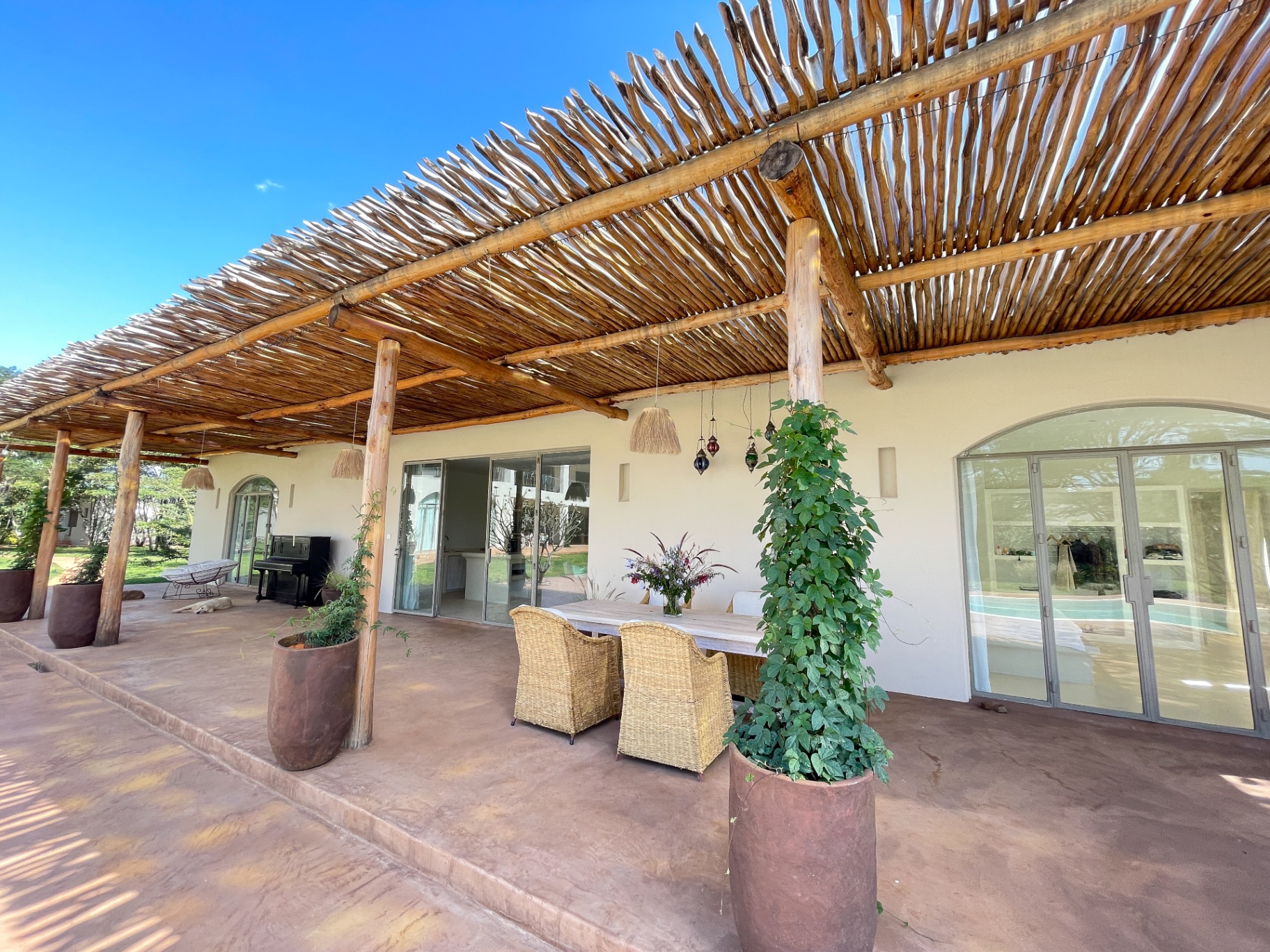 Pool House veranda with mangrove-pole pergola and dining table